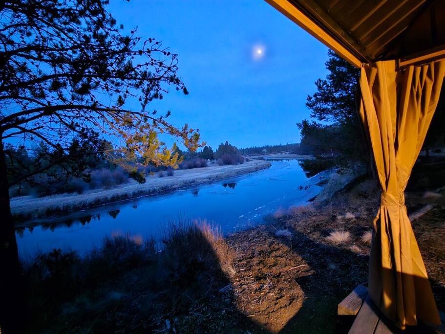 a view of a river at night from a tent at Beautiful Riverfront Near Mt Bachelor with Hot Tub in Bend