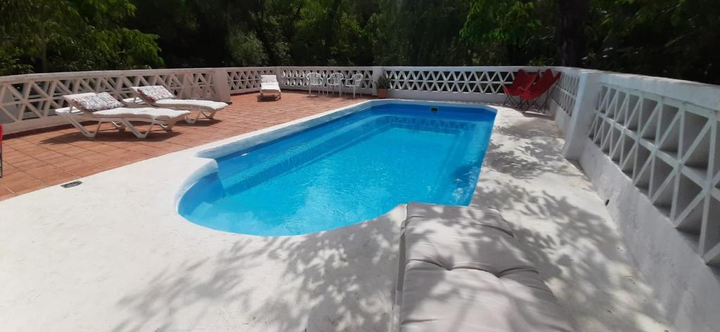a swimming pool on top of a white fence at Molino de Gris Cazorla in Chilluévar