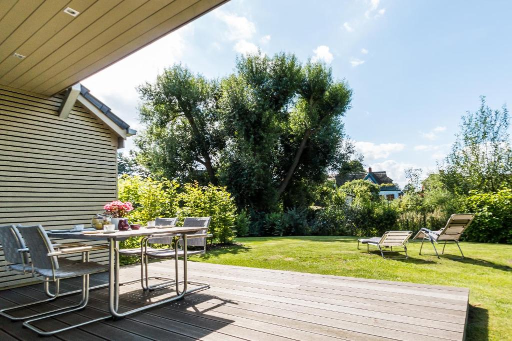a patio with a table and chairs on a deck at Zweienhaus 02 in Wieck