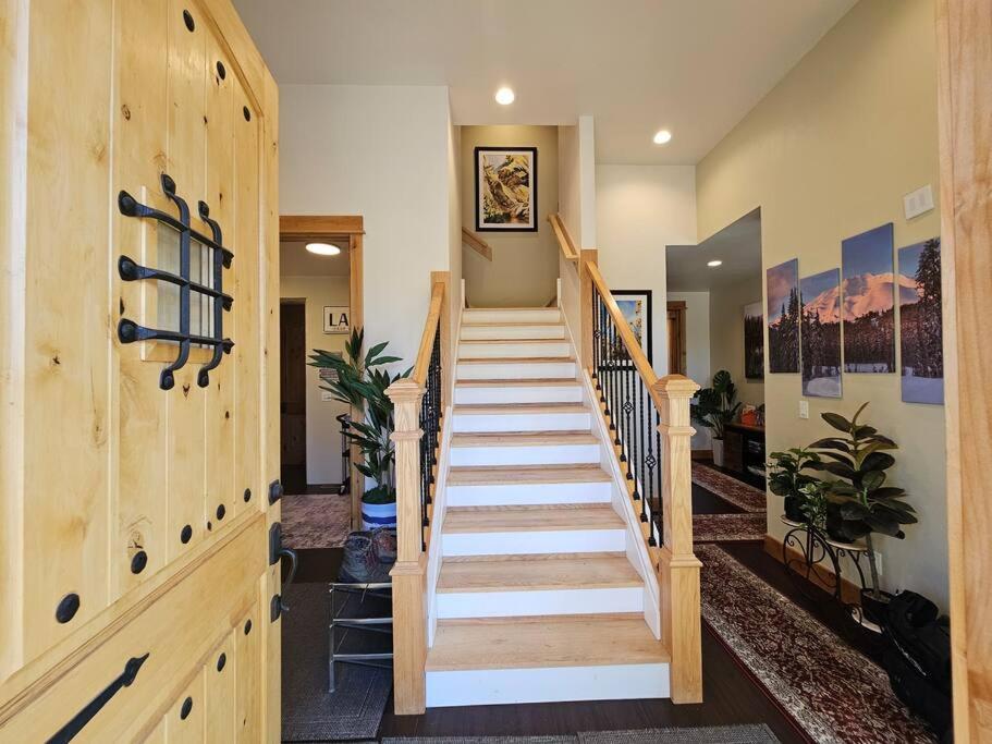 a staircase in a home with a wooden wall at Beautiful Riverfront Near Mt Bachelor with Hot Tub in Bend