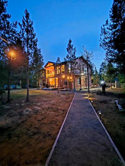 a walkway in front of a house at night at Beautiful Riverfront Near Mt Bachelor with Hot Tub in Bend