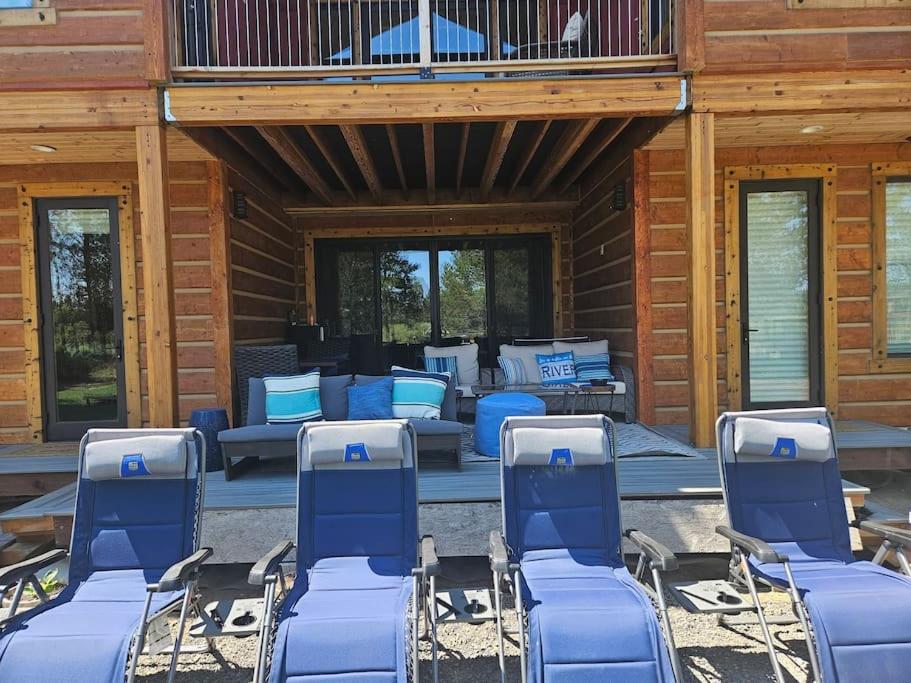 a group of blue chairs sitting on a patio at Beautiful Riverfront Near Mt Bachelor with Hot Tub in Bend