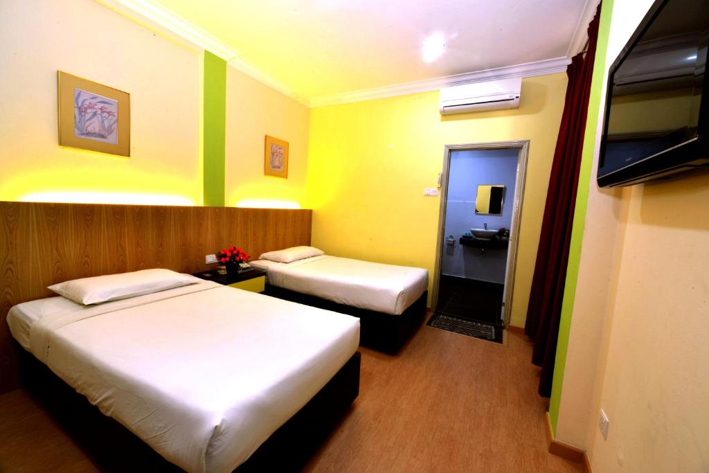 Postel nebo postele na pokoji v ubytování Classic Boutique Hotel Kuantan