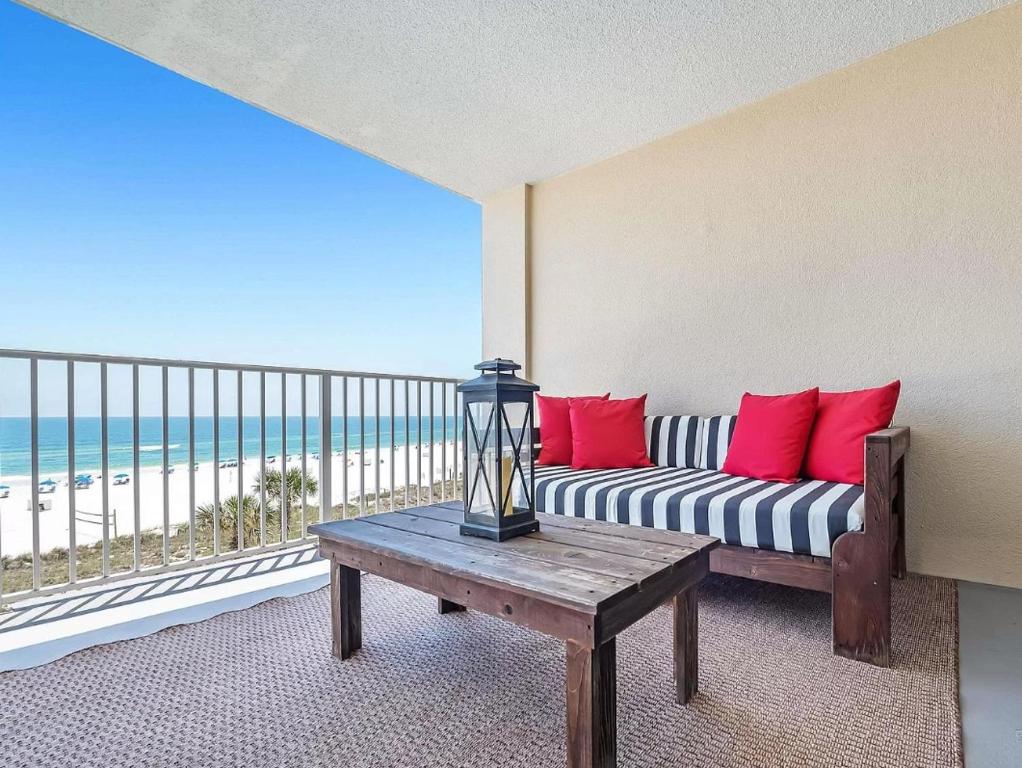a living room with a couch and a view of the beach at Bluewater Unit 404 in Orange Beach