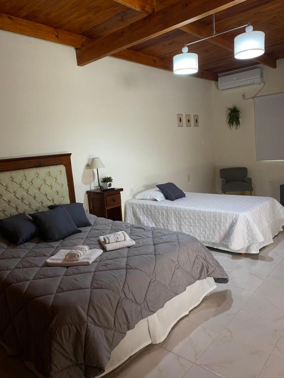 a bedroom with two beds with towels on them at Oc temporarios in Paso de los Libres