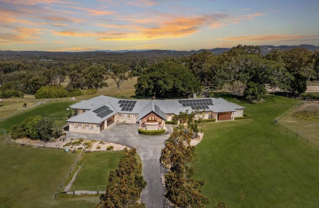 an aerial view of a house with solar panels on it at Luxury Range Stay! 6 Bedroom 4 Bathroom in Thornlands