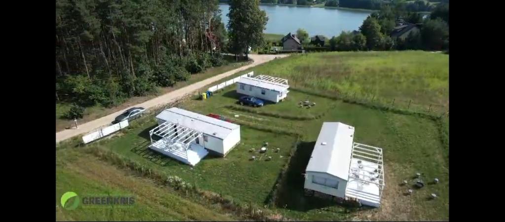 an aerial view of a farm with animals in a field at GreenKris in Ostaszewo