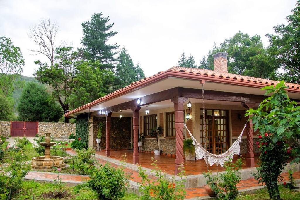 a small house with a porch at La Pradera, Casa de Campo Privada, 2-14 Personas - Cambio Oficial in Tarija