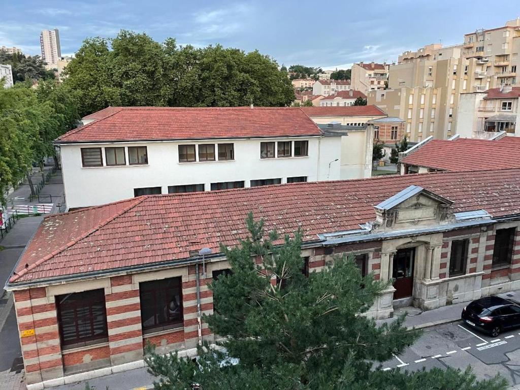 an old building with a red roof in a city at Tréfilerie in Saint-Étienne
