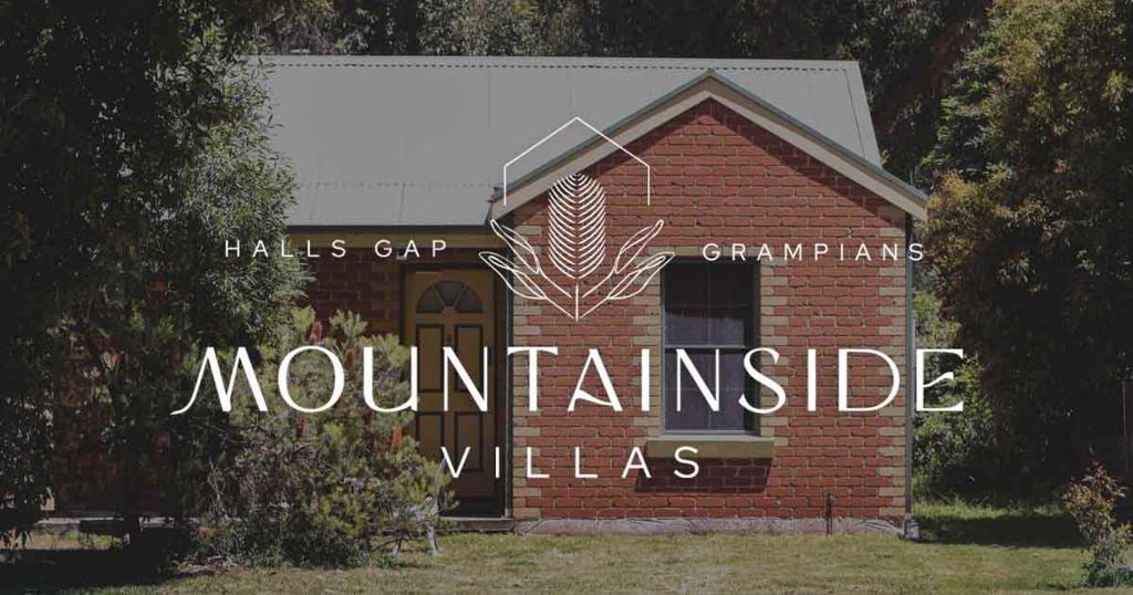 a red brick building with a sign on it at Mountainside Villas Halls Gap in Halls Gap
