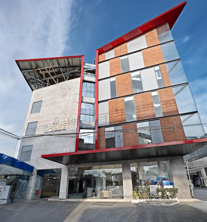 a tall building with a red at D-Luxe Hotel in Cochin
