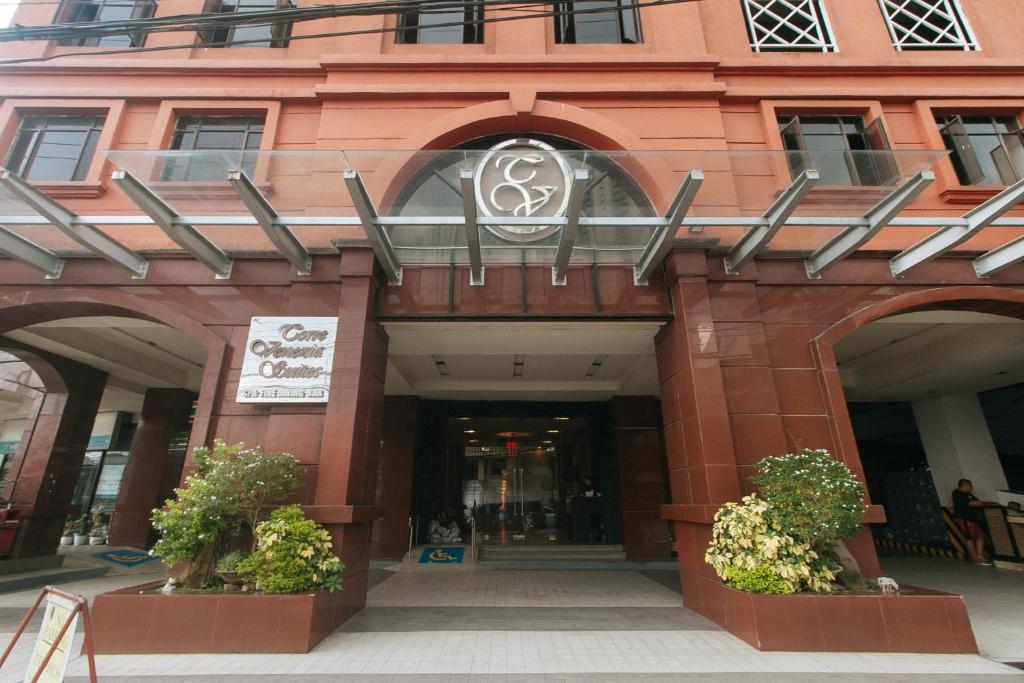 a building with two plants in front of it at Torre Venezia Suites in Manila