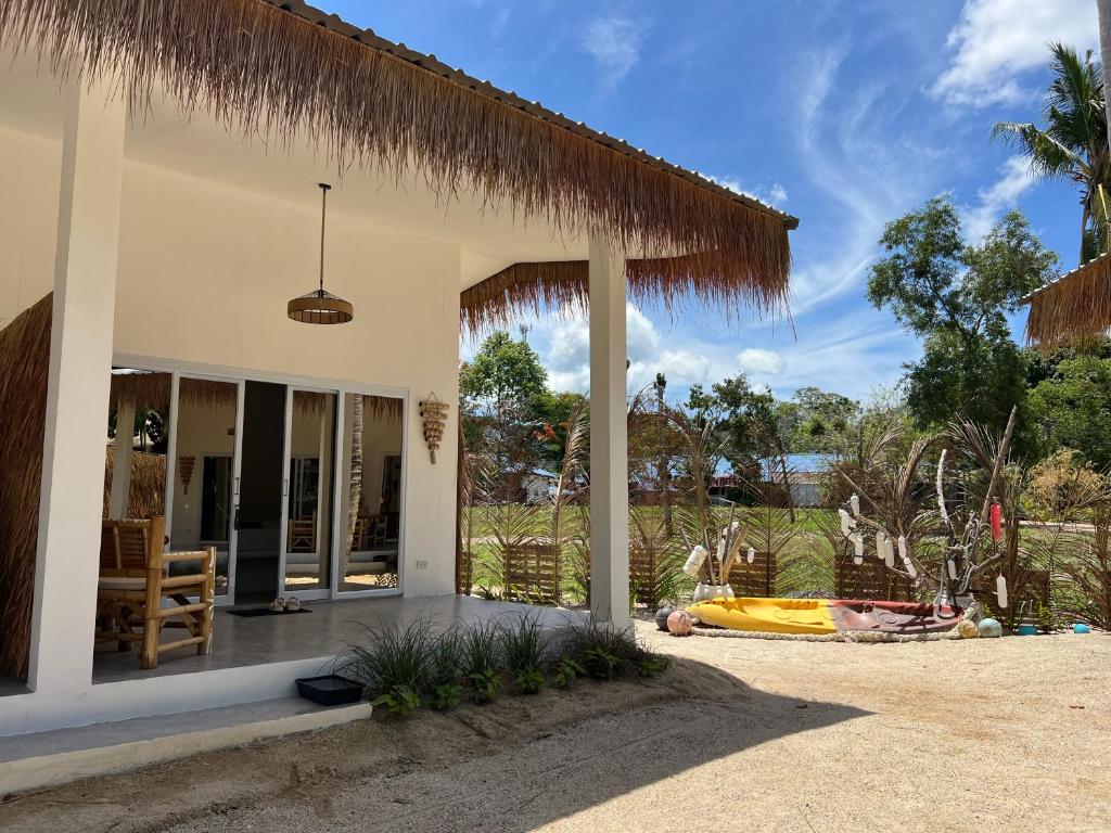 a house with a porch with a pineapple roof at Sea Love Beach Bar & Bungalows in Ban Tai