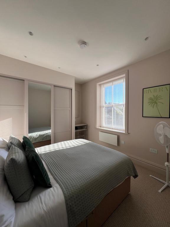 a bedroom with a large bed and a window at The Apartments Lytham Square in Lytham St Annes