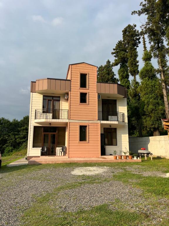 a large house with a balcony on top of it at Guest House in Batumi