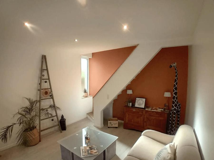 a living room with a white couch and a table at La maison cozy Tandem proche gare parking wifi in Chartres
