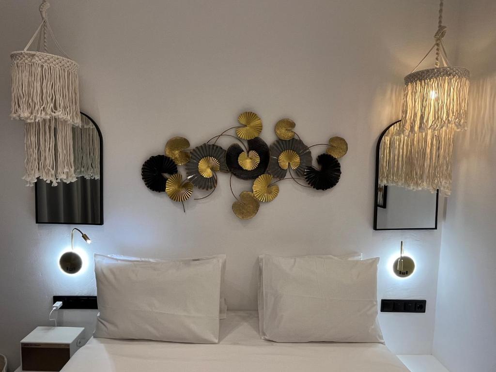 a room with a bed with flowers on the wall at Skopelos Holidays Hotel & Spa in Skopelos Town