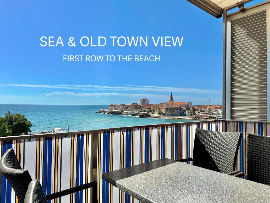 a balcony with a table and chairs and the ocean at Apartment Elaine's View in Umag
