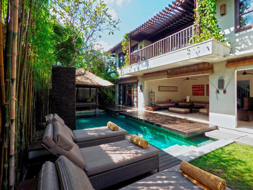 a swimming pool in the backyard of a house at The Amala Boutique Retreat in Seminyak