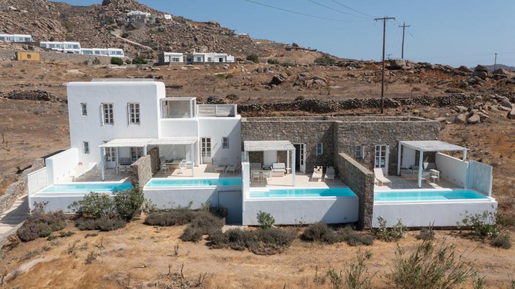 a villa with a swimming pool in the desert at The Ammonite Resort in Super Paradise Beach