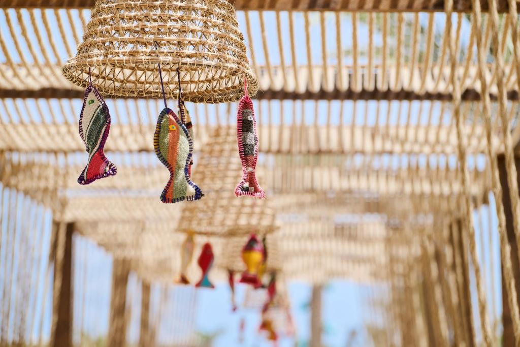 a hanging basket with fish hanging from a ceiling at Iberostar Waves Mehari Djerba in Taguermess