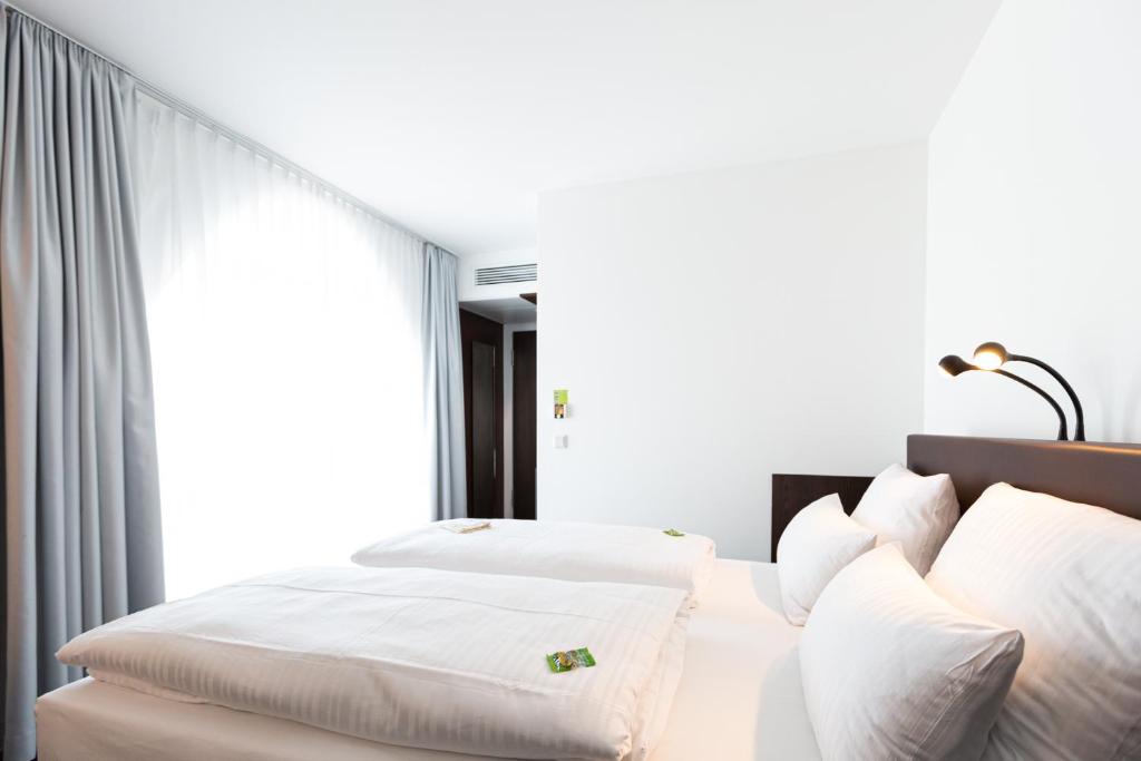Postel nebo postele na pokoji v ubytování Tobbaccon Hotel