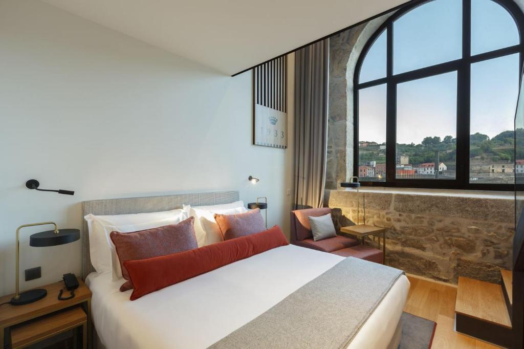 Postel nebo postele na pokoji v ubytování NEYA Porto Hotel