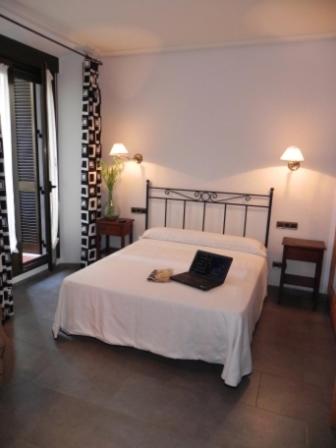 Postel nebo postele na pokoji v ubytování Hostal Ivor