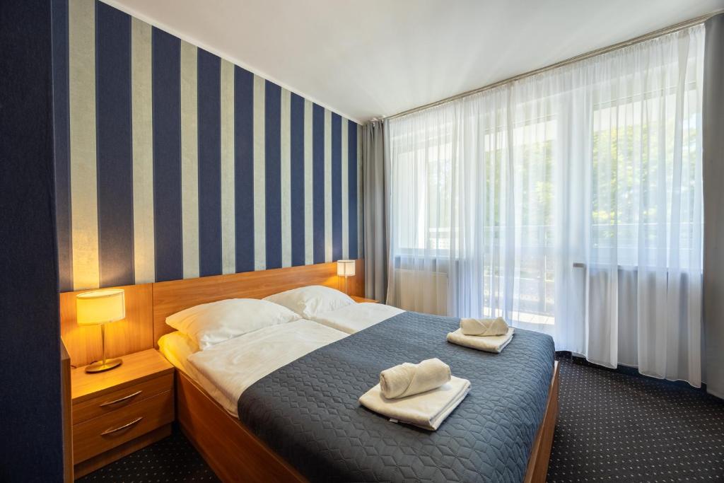 Łóżko lub łóżka w pokoju w obiekcie Baltic Inn