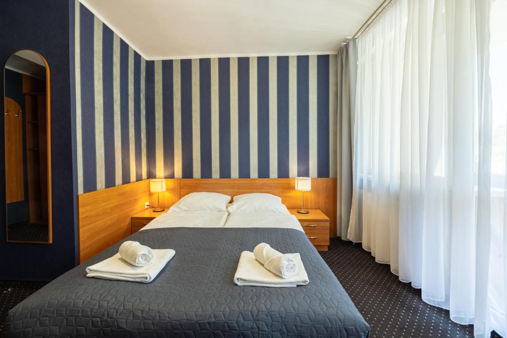 Łóżko lub łóżka w pokoju w obiekcie Baltic Inn