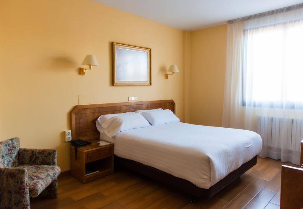 Postel nebo postele na pokoji v ubytování Hotel Don Carmelo