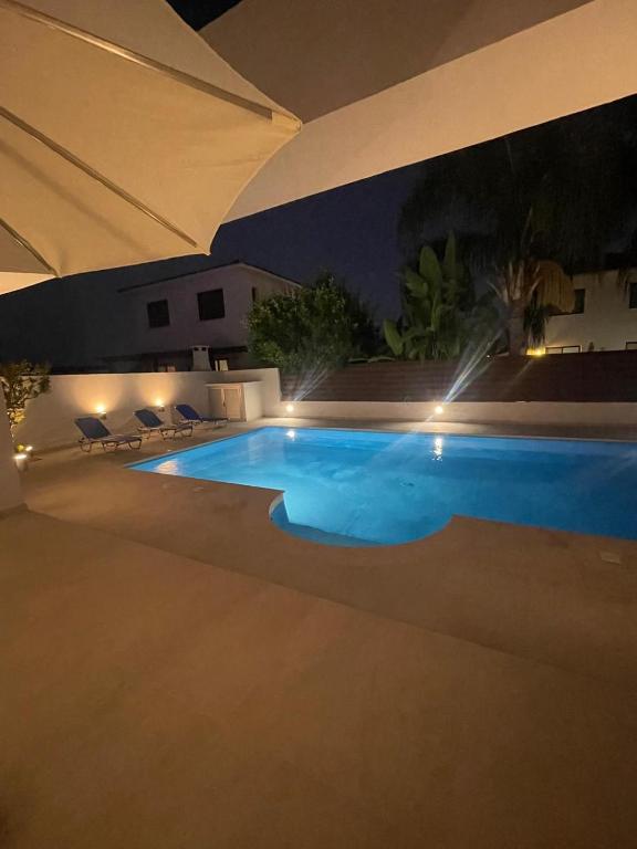 a swimming pool at night with lights on it at Katikies Grand - Superior Villa Adults Only in Pissouri