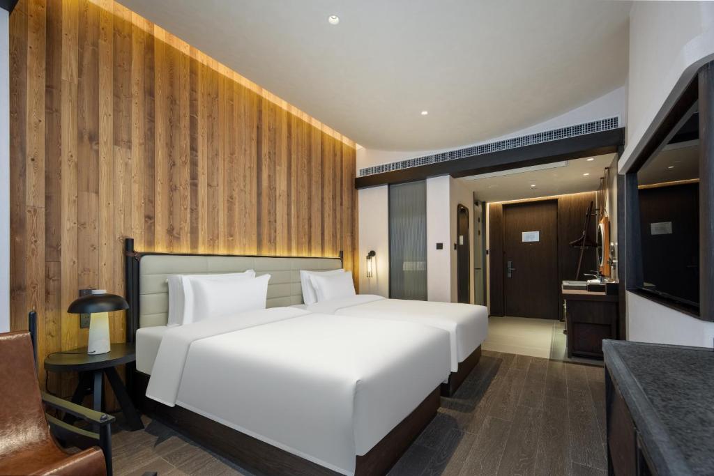 Postel nebo postele na pokoji v ubytování Presidential Palace YiLi Hotel Nanjing