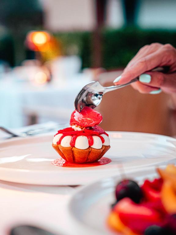 a person is eating a dessert with a spoon at Domaine de l'Astragale in Saint-Tropez