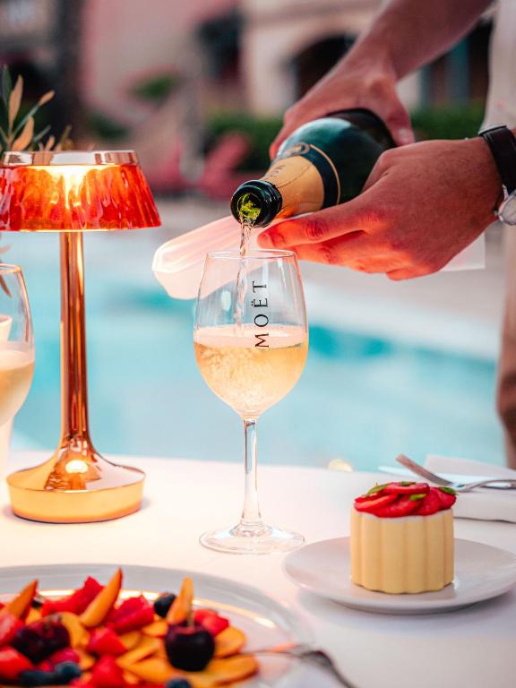 a person pouring wine into a wine glass at Domaine de l'Astragale in Saint-Tropez