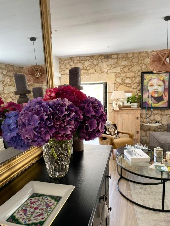 a vase of flowers on a table in a living room at La Maison du Clocher in Saint-Émilion