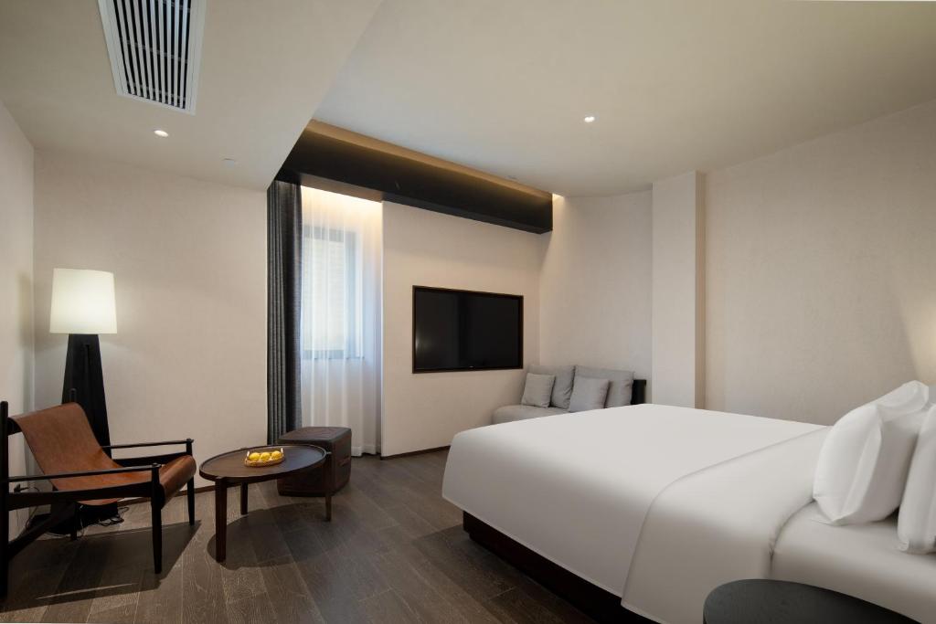 Postel nebo postele na pokoji v ubytování Presidential Palace YiLi Hotel Nanjing
