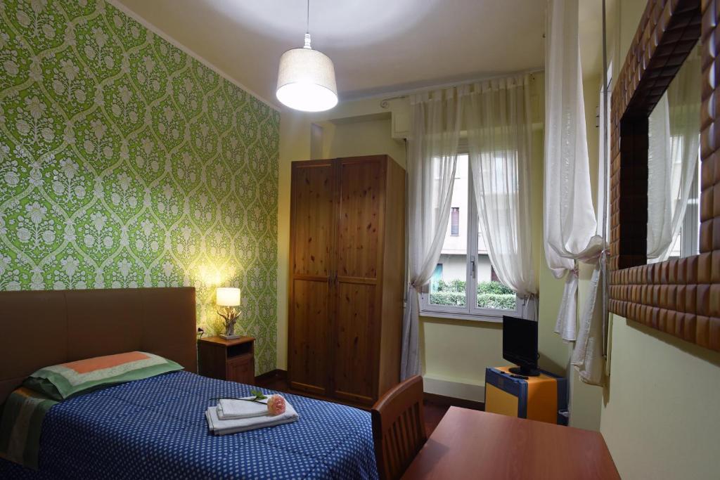 a small bedroom with a bed and a window at B&B Sant'Agostino in Milan