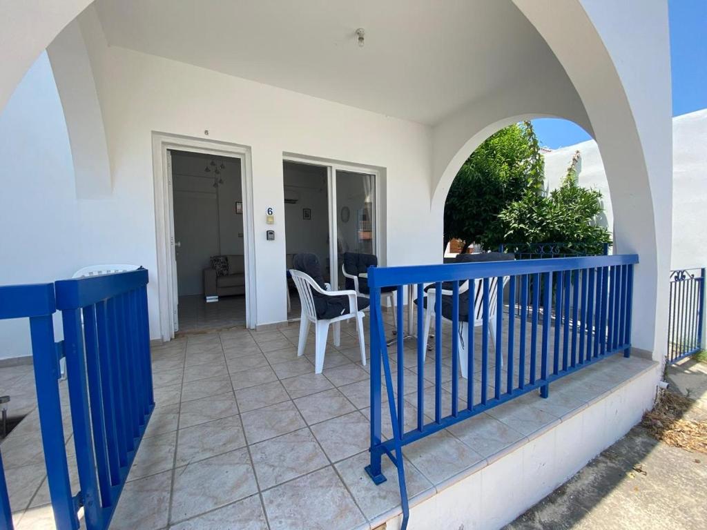 a balcony with a blue railing and a table at Polis Chrysochous Entire Apartment in Polis Chrysochous