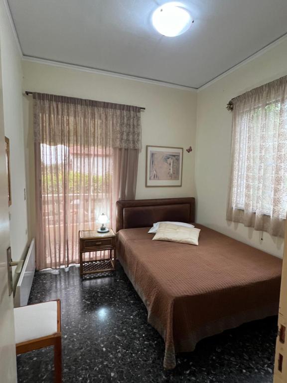 Postel nebo postele na pokoji v ubytování Ζαχάρω Suite