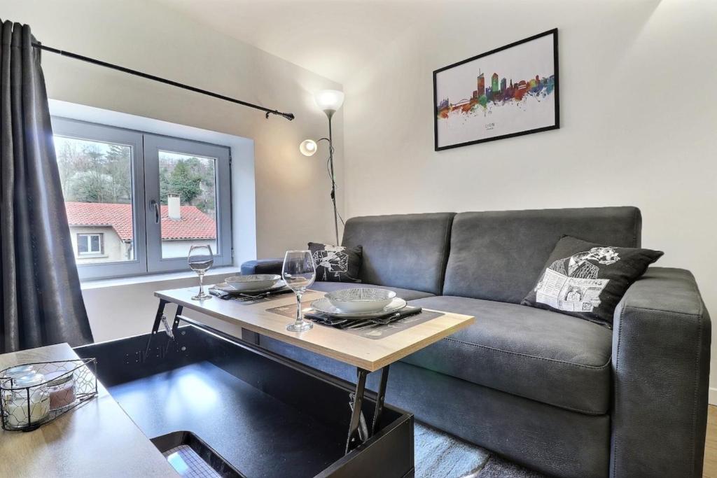 a living room with a couch and a table at Le St Clair 401 - Luxury equipped apartment - Caluire-et-Cuire in Caluire-et-Cuire