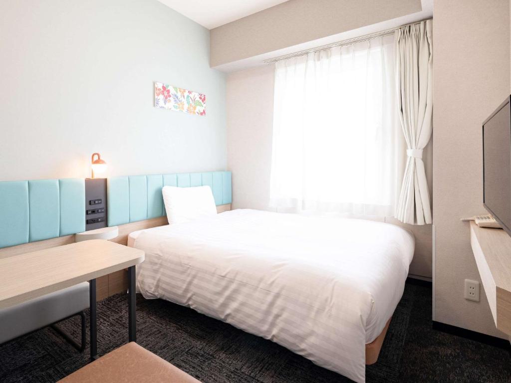 Postel nebo postele na pokoji v ubytování Comfort Hotel Naha Prefectural Office