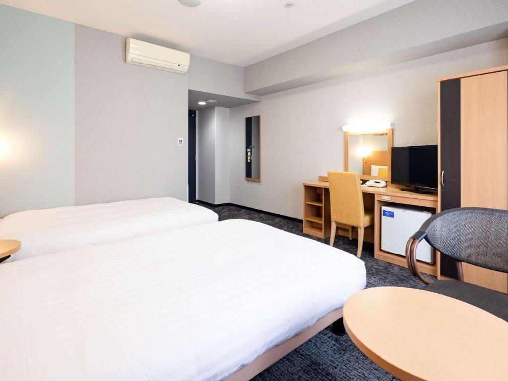 Postel nebo postele na pokoji v ubytování Comfort Hotel Naha Prefectural Office