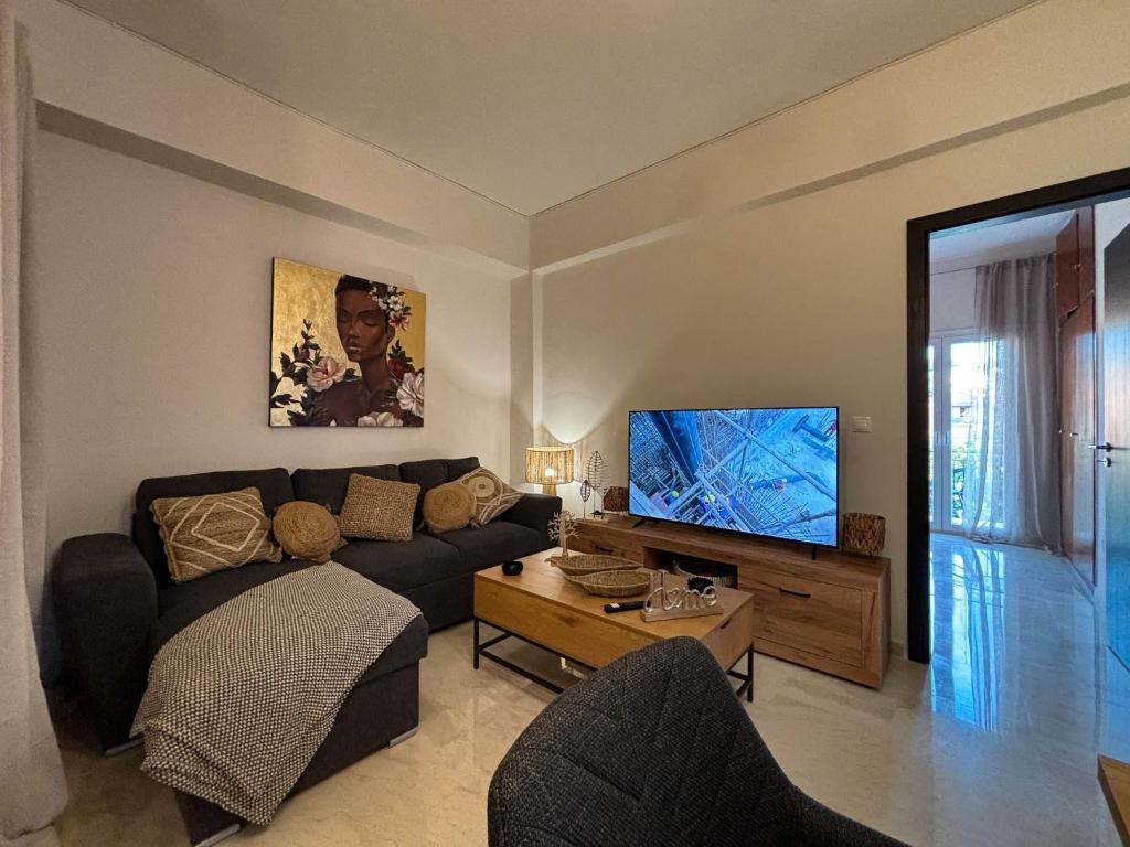 a living room with a couch and a flat screen tv at Kassiopi Bella Vista in Kassiopi