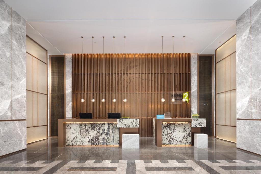 a rendering of a lobby with a reception desk at Home2 Suite by Hilton Wuhan Economic Development Zone in Wuhan