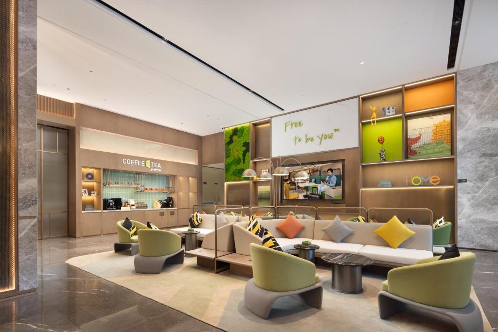 a lobby of a store with couches and chairs at Home2 Suite by Hilton Wuhan Economic Development Zone in Wuhan