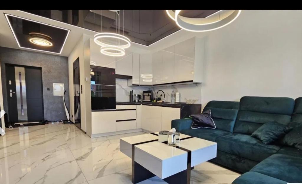 un soggiorno con un divano e un tavolo di Apartament De LUX Wrzosowo Dziwnówek a Dziwnówek
