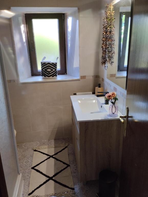 a bathroom with a sink and a window at Casa de Valeria in Tomiño