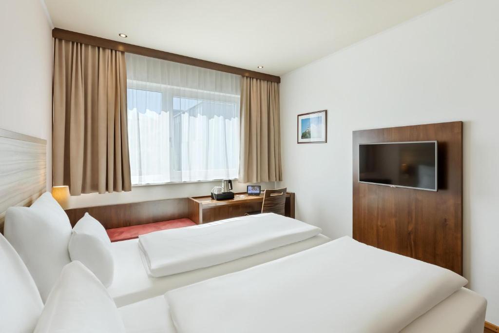Postel nebo postele na pokoji v ubytování Austria Trend Hotel Salzburg Messe