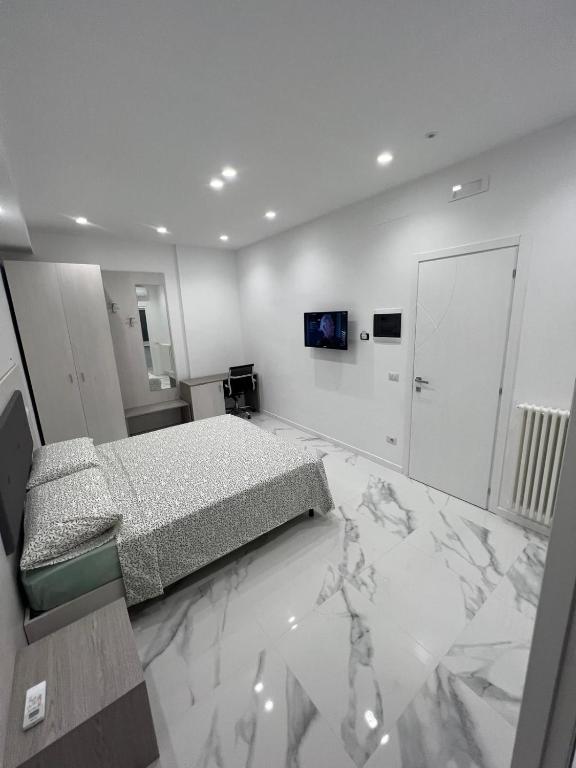 a bedroom with a bed on a marble floor at Alba White in Rome